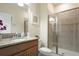 Bathroom with granite countertop sink and shower with glass door at 4879 Clock Tower Dr, Kissimmee, FL 34746