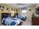 Fun bedroom with Mickey Mouse decor, featuring two twin beds and a ceiling fan at 4879 Clock Tower Dr, Kissimmee, FL 34746