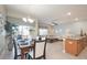 Open-concept dining room with modern light fixture and adjacent living room area at 4879 Clock Tower Dr, Kissimmee, FL 34746
