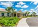Clubhouse exterior with stone entrance and lush landscaping at 4879 Clock Tower Dr, Kissimmee, FL 34746