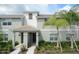 Inviting townhome exterior with well-maintained landscaping and covered front porch entry at 4879 Clock Tower Dr, Kissimmee, FL 34746