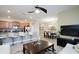 Open-concept kitchen with breakfast bar, stainless steel appliances, and adjacent dining area at 4879 Clock Tower Dr, Kissimmee, FL 34746