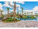 Lazy river with a bridge and lush landscaping offering a serene and picturesque water recreation experience at 4879 Clock Tower Dr, Kissimmee, FL 34746