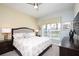 Serene main bedroom features a large window, ceiling fan and plenty of natural light at 4879 Clock Tower Dr, Kissimmee, FL 34746