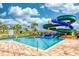 Community pool area featuring a winding water slide, palm trees, clear blue water, and comfortable seating at 4879 Clock Tower Dr, Kissimmee, FL 34746
