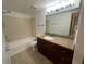 Bathroom featuring a granite vanity top and tiled shower with tub at 5120 Conroy Rd # 513, Orlando, FL 32811