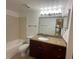 Bathroom with a granite vanity top and tiled shower with tub and newer fixtures at 5120 Conroy Rd # 513, Orlando, FL 32811