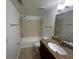 Bathroom with a granite-topped vanity, a shower-tub combo, and tile floors at 5120 Conroy Rd # 513, Orlando, FL 32811