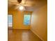 Bright bedroom with a ceiling fan, window, and glass door leading outside at 5120 Conroy Rd # 513, Orlando, FL 32811