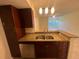 Kitchen featuring granite countertops, stainless steel sink, dark wood cabinets, and modern fixtures at 5120 Conroy Rd # 513, Orlando, FL 32811