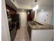 Modern kitchen with granite countertops, stainless steel appliances, and dark wood cabinets at 5120 Conroy Rd # 513, Orlando, FL 32811