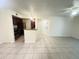 Open-concept living space with tile flooring and a breakfast bar that looks into the stainless steel kitchen at 5120 Conroy Rd # 513, Orlando, FL 32811