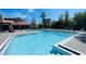 A well-maintained community pool on a sunny day with plenty of lounge chairs to relax in at 5120 Conroy Rd # 513, Orlando, FL 32811