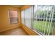 Bright sun room features neutral paint, tile flooring, and a large window with views of greenery at 5120 Conroy Rd # 513, Orlando, FL 32811