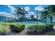 A tennis court surrounded by green space and blue skies at 5120 Conroy Rd # 513, Orlando, FL 32811