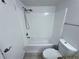 Bathroom featuring shower over tub, tile floors, and updated lighting at 5128 Conroy Rd # 725, Orlando, FL 32811