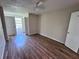 Spacious bedroom with wood-look floors, ceiling fan, and natural light at 5128 Conroy Rd # 725, Orlando, FL 32811