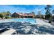 Community pool with lounge seating and clubhouse at 5128 Conroy Rd # 725, Orlando, FL 32811