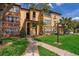 Beautiful condo building featuring well-maintained landscaping and charming architectural details at 5128 Conroy Rd # 725, Orlando, FL 32811