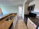 Cozy kitchen features stainless steel appliances, white cabinets, and granite countertops at 5128 Conroy Rd # 725, Orlando, FL 32811