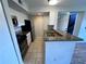 Well-lit kitchen with stainless steel appliances and granite countertops at 5128 Conroy Rd # 725, Orlando, FL 32811