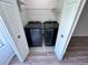 Washer and dryer in closet of bedroom with wood-look flooring at 5128 Conroy Rd # 725, Orlando, FL 32811