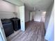 Laundry room with Samsung washer/dryer leading to open bedroom/bathroom at 5128 Conroy Rd # 725, Orlando, FL 32811