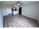 Bright living room featuring wood floors, a ceiling fan, and easy access to kitchen at 5128 Conroy Rd # 725, Orlando, FL 32811