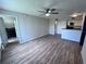 Spacious living room featuring wood floors, ceiling fan and direct access to laundry at 5128 Conroy Rd # 725, Orlando, FL 32811