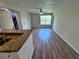 Bright living room featuring wood floors and large window offering great views at 5128 Conroy Rd # 725, Orlando, FL 32811
