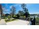 A patio overlooking a pond with chairs, picnic tables, and beautiful landscaping at 5128 Conroy Rd # 725, Orlando, FL 32811