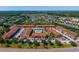 Aerial view of a condo community featuring a swimming pool, lush landscaping, and convenient parking at 5201 Vineland Rd # 112, Orlando, FL 32811