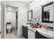 Bathroom with double sink vanity and an adjacent water closet for added convenience at 5201 Vineland Rd # 112, Orlando, FL 32811
