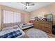 Cozy bedroom featuring two beds, natural light, and a ceiling fan at 5201 Vineland Rd # 112, Orlando, FL 32811