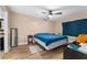 Comfortable bedroom featuring wood-look floors, ceiling fan, and ample space at 5201 Vineland Rd # 112, Orlando, FL 32811