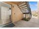 Exterior entrance featuring open front door to the home, staircase, and neutral stucco at 5201 Vineland Rd # 112, Orlando, FL 32811