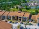 Exterior view of a condo building with a brown roof, neutral siding, balconies, and ample parking at 5201 Vineland Rd # 112, Orlando, FL 32811