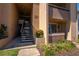 Exterior view of a building featuring stairs leading to the upper levels and landscaped plants at 5201 Vineland Rd # 112, Orlando, FL 32811