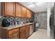 Kitchen with granite countertops, tile backsplash and stainless steel appliances at 5201 Vineland Rd # 112, Orlando, FL 32811