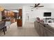 Open floor plan with living room with tile floors, neutral paint and kitchen with stainless steel appliances at 5201 Vineland Rd # 112, Orlando, FL 32811