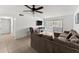 Living room featuring tile flooring, a comfortable sofa, ceiling fan and a sliding glass door at 5201 Vineland Rd # 112, Orlando, FL 32811