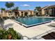 Community pool with lounge chairs and well-maintained landscaping at 5201 Vineland Rd # 112, Orlando, FL 32811