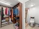 Walk-in closet with custom shelving and easy access to an ensuite bath at 5201 Vineland Rd # 112, Orlando, FL 32811