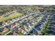 An aerial view showcases the vibrant neighborhood, featuring numerous homes with pristine landscaping and community amenities at 6148 Gracie Pl, Lakeland, FL 33812