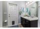 This bathroom features a vanity with granite countertops and a door with pet access at 6148 Gracie Pl, Lakeland, FL 33812