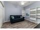 This bedroom features wood floors, a sofa, and a window at 6148 Gracie Pl, Lakeland, FL 33812