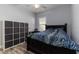 Cozy bedroom with a dark bed frame, modern storage cube organizer and a view of the window at 6148 Gracie Pl, Lakeland, FL 33812