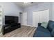 This bedroom features wood floors, a sofa, a window and a TV setup at 6148 Gracie Pl, Lakeland, FL 33812