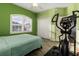 Cozy bedroom with a bed, a ceiling fan, ample natural light from the window, and a spacious closet at 6148 Gracie Pl, Lakeland, FL 33812