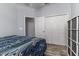 This bedroom features wood floors, a ceiling fan, and a closet for ample storage at 6148 Gracie Pl, Lakeland, FL 33812